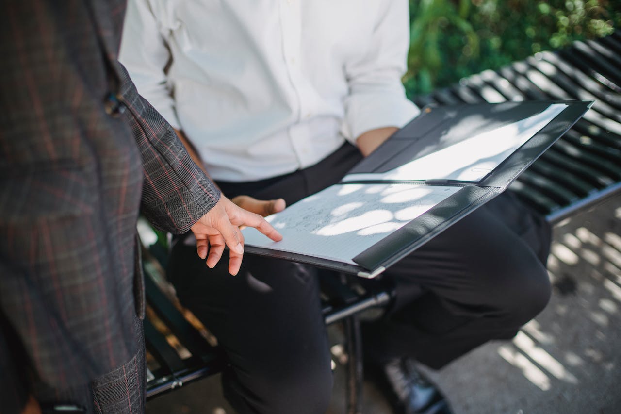 Person Pointing a Finger on a Document